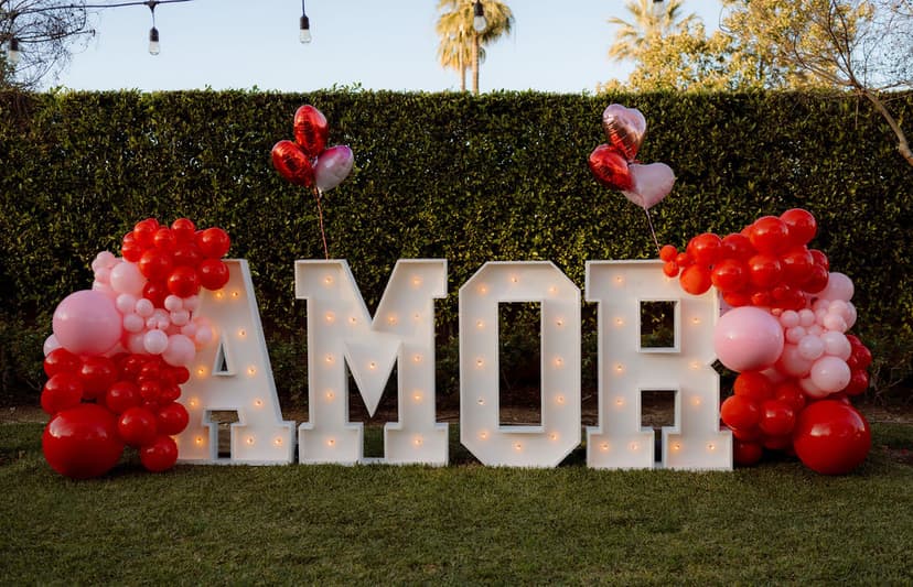 Heart-themed Galentines lounge with marquee word display