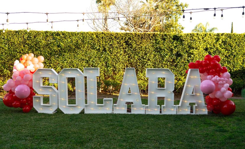 Galentines photo moment centered on glowing decorative letters